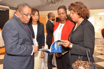 JAMPRO President Diane Edwards (right) shows the complete National Export Strategy II to (From L-R) the Honourable Minister of Industry, Investment and Commerce, G. Anthony Hylton, the Honourable Minister of State, Sharon Ffolkes Abrahams and Adviser (Trade Competitiveness) Trade Division at the Commonwealth Secretariat, Yinka Bandele. The Commonwealth Secretariat collaborated with the Ministry of Industry, Investment and Commerce, JAMPRO, Trade Board Limited and the Jamaica Exporters Association (JEA) to create the second phase of Jamaica's National Export Strategy, which is a 4 year programme that aims to boost exports. 