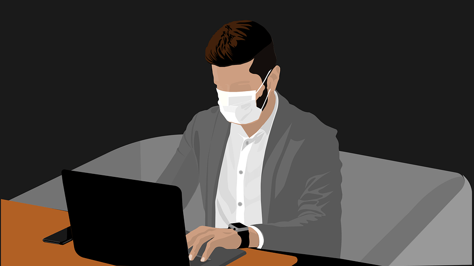 Man at desk wearing a mask